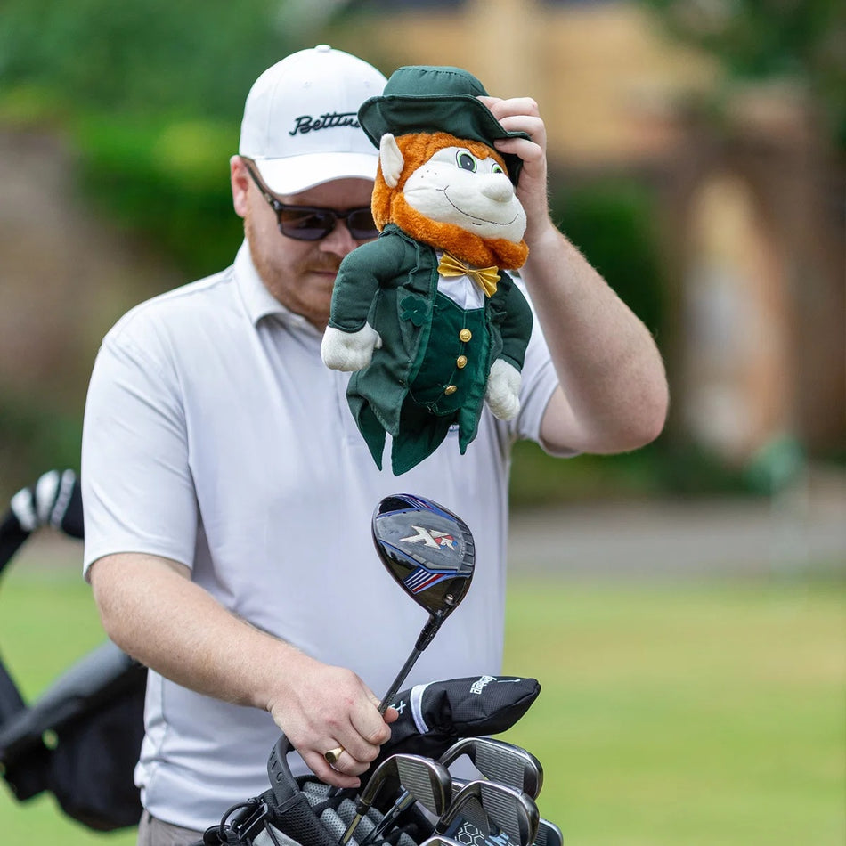 Golfer holding a Longridge Leprechaun headcover above an uncovered driver