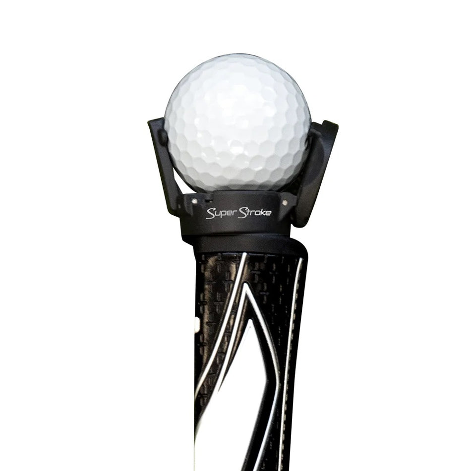 SuperStroke Ball Pick Up attached to a putter grip holding a golf ball