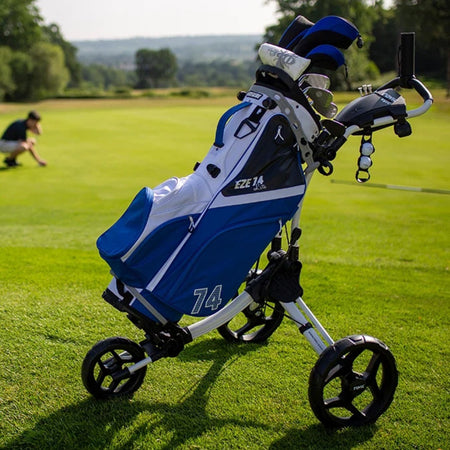 Rovic RV1C 2.0 Golf Push Trolley carrying a blue and white golf bag on the course (bag and clubs not included)