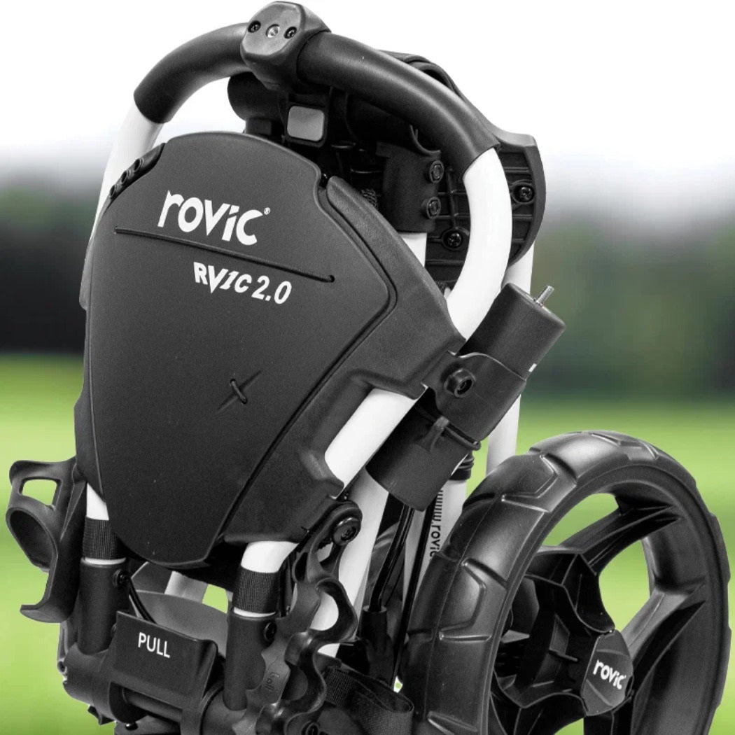 Folded Rovic RV1C 2.0 in Arctic/Black golf trolley outdoors