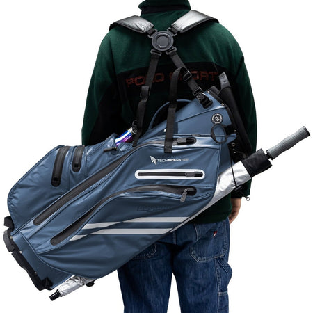 Golfer carrying a BagBoy Technowater Hybrid Stand Bag in Navy with the dual strap harness