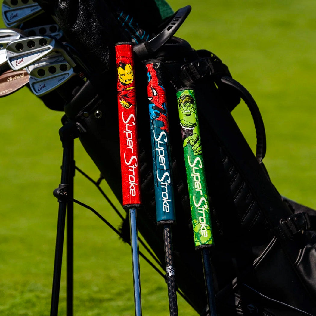 SuperStroke Marvel Iron Man, Spider-Man and Hulk putter grips displayed beside a golf bag (bag not  included)