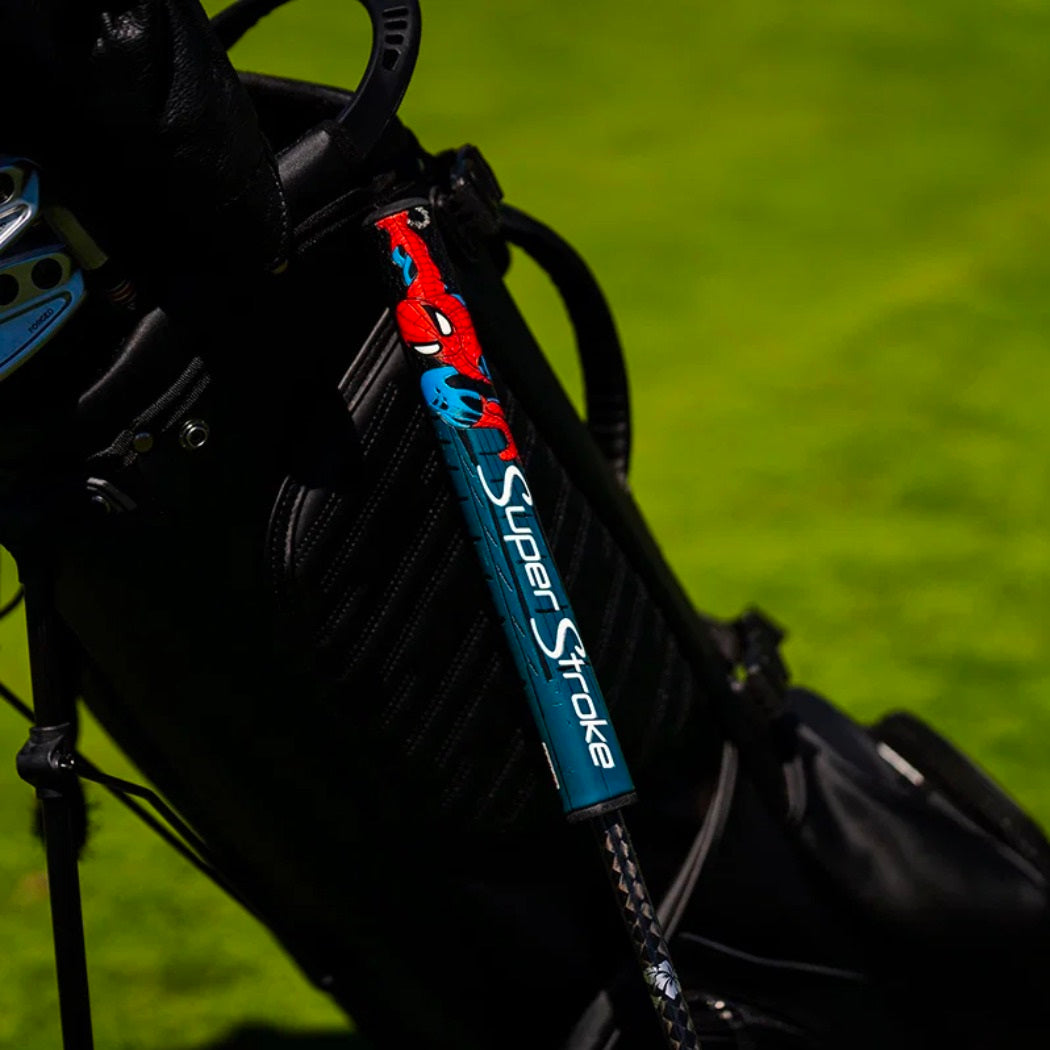 SuperStroke Marvel Spider-Man putter grip fitted to a putter beside a golf bag (bag not included)