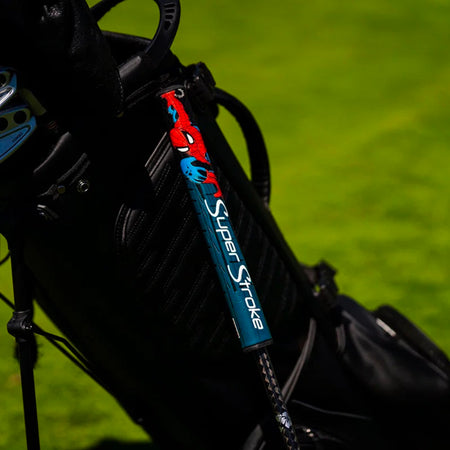 SuperStroke Marvel Spider-Man putter grip fitted to a putter beside a golf bag (bag not included)